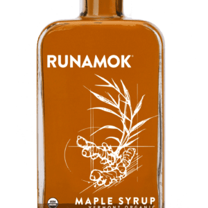 A bottle of maple syrup on top of a green background.