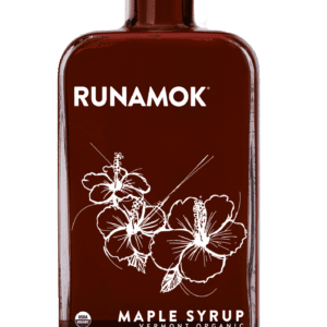 A bottle of maple syrup with flowers on it.