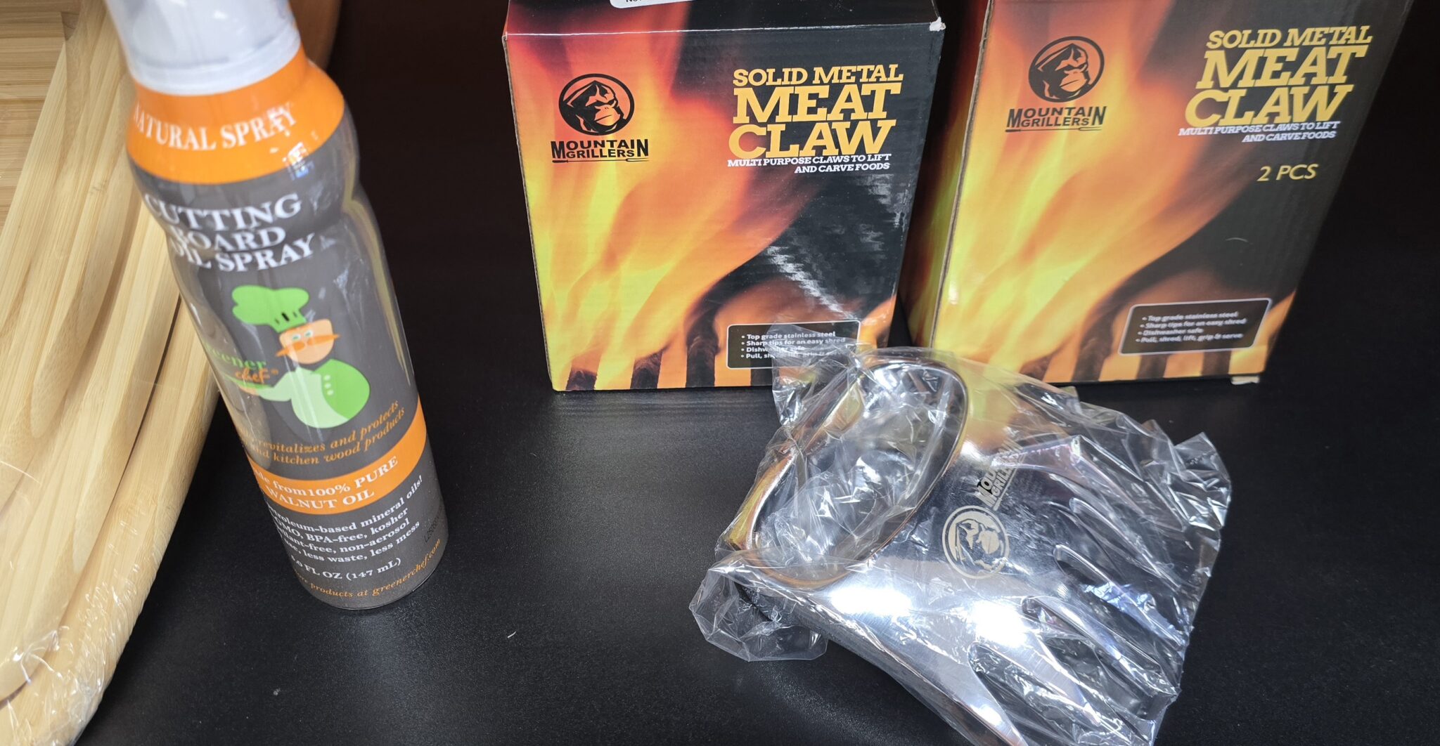 Meat claws and cutting board spray on table.