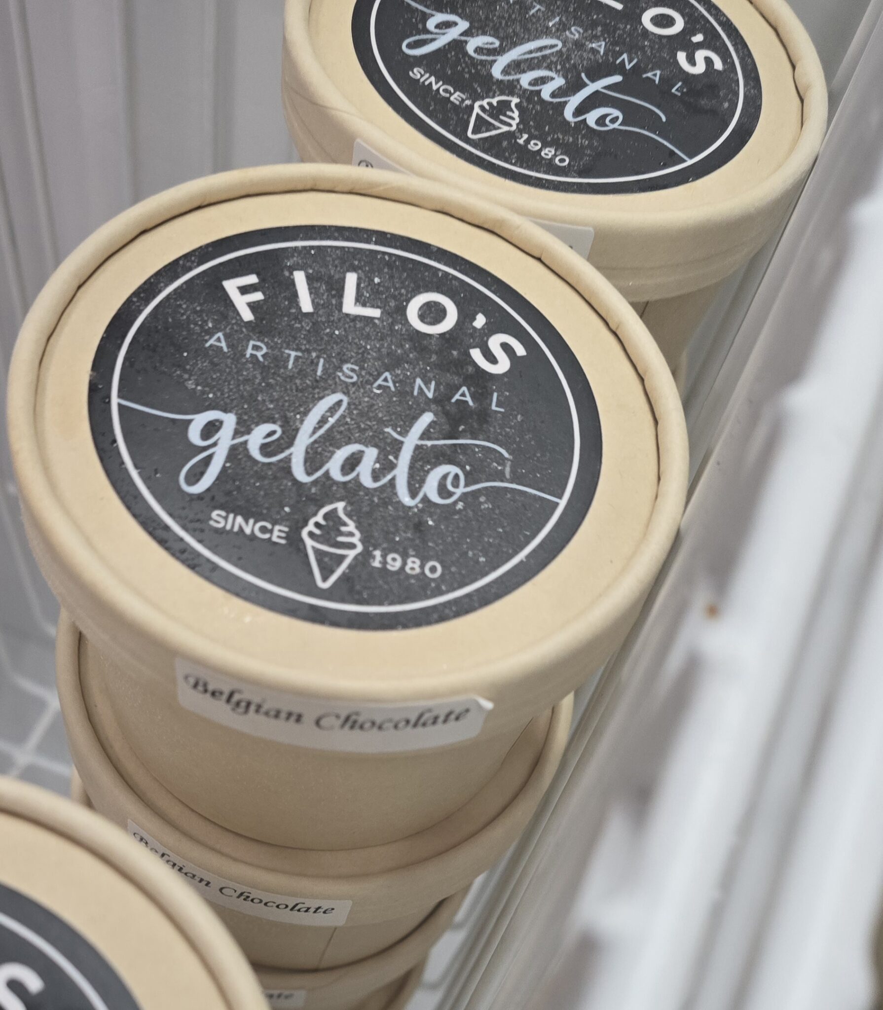 Artisanal gelato tubs in a freezer.
